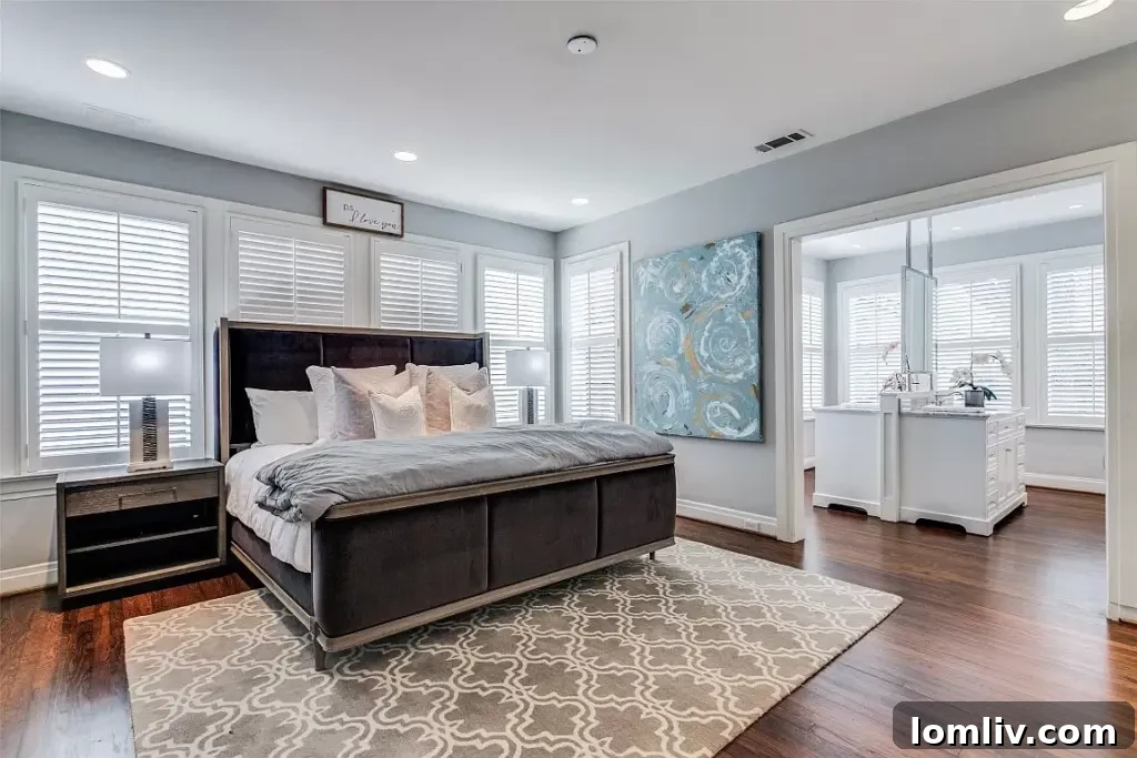 Bright and airy primary bedroom with large windows overlooking the backyard.