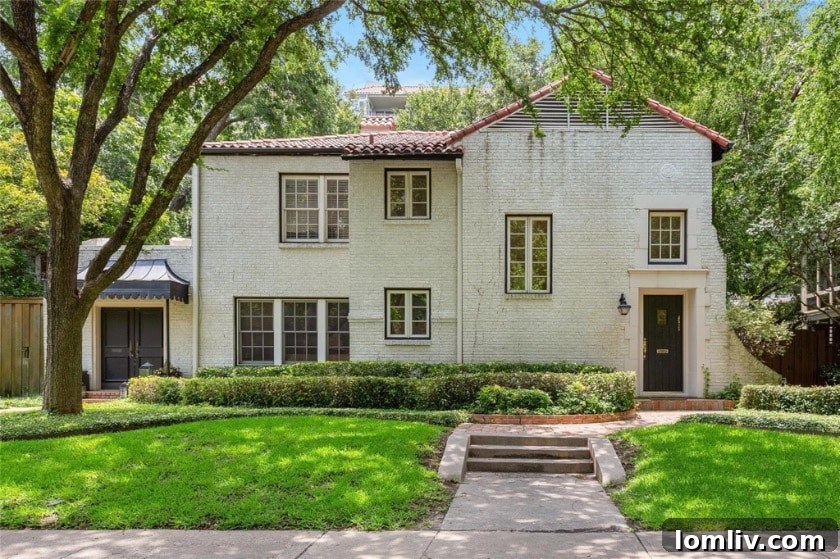 Classic Spanish Colonial Revival duplex exterior in Highland Park, Dallas, showcasing a red tile roof and stucco walls.