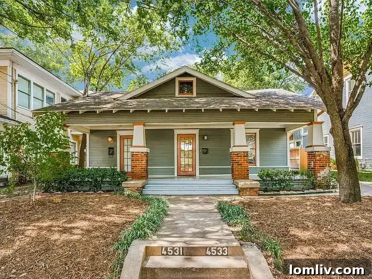 Classic American Craftsman style home with a wide porch and low-pitched roof, showcasing traditional architectural details.