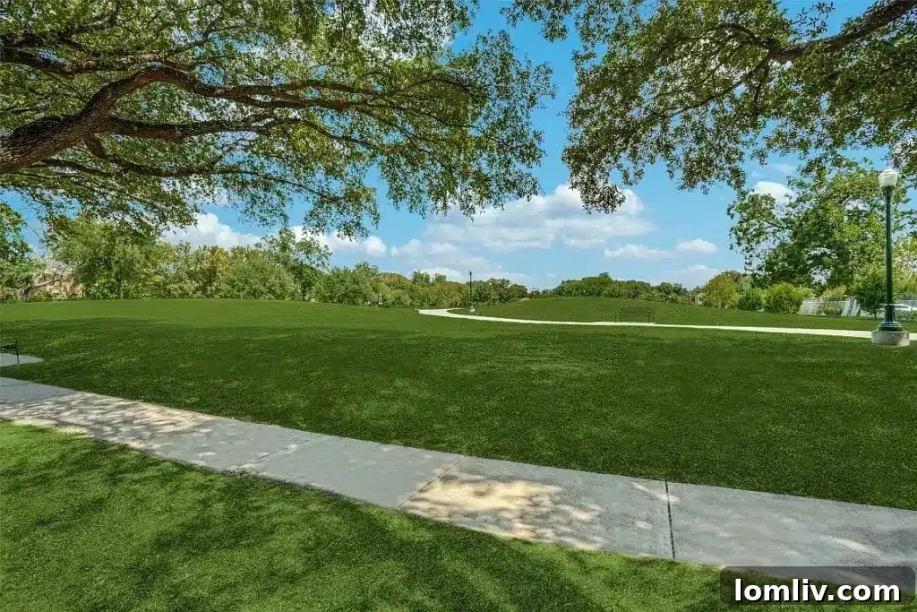 Bright outdoor courtyard featuring lush greenery and a mature pecan tree, perfect for relaxation.