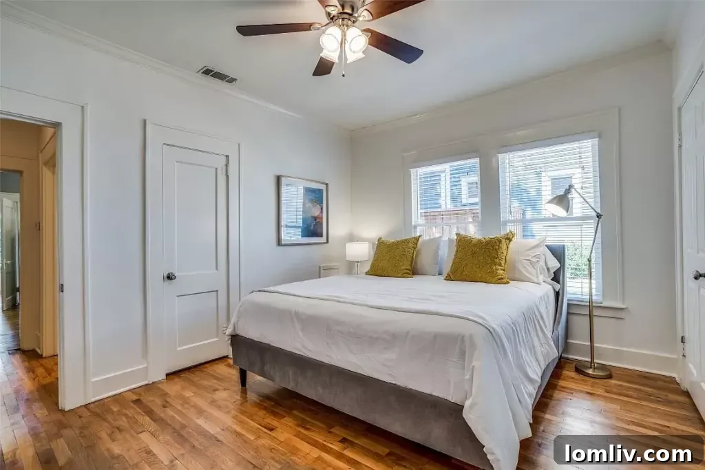 Cozy bedroom featuring warm lighting, traditional furniture, and a charming window.