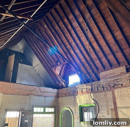 Interior undergoing transformation, with vaulted ceilings becoming visible.