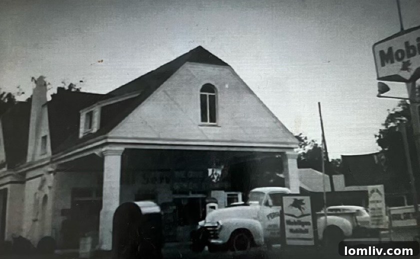 Black and white historical image showing the Tudor architecture of the gas station.