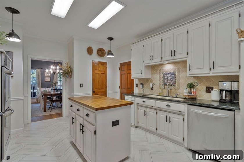 RE/MAX DFW Associates Liz Snowden Uncovers a Prime Flower Mound Property 7 Modern kitchen with stainless steel appliances, granite countertops, and a butcher block island