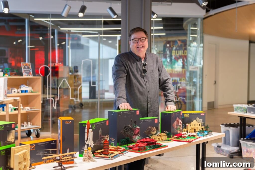 Blane Ladymon proudly stands with his personal LEGO collection, showcasing various architectural models, during last year’s AD | EX Brickitecture Family Build Day.