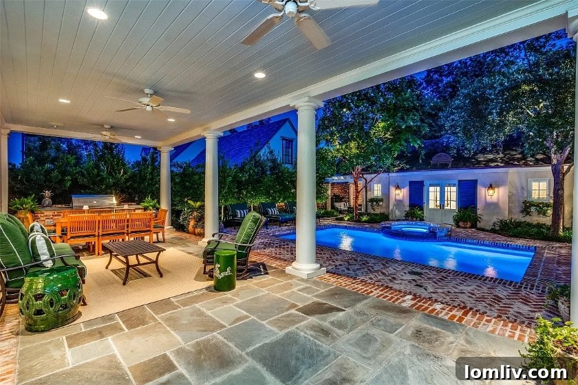 Inviting swimming pool and spa area with lush landscaping, adjacent to the guest house.