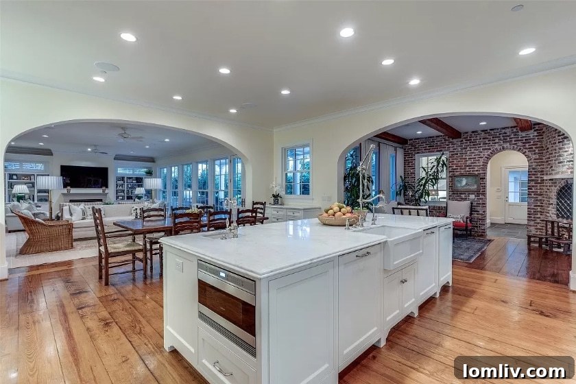 Spacious kitchen with a central island and high-end appliances, part of an open-plan living area.