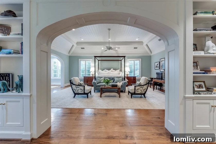 Luxurious principal bedroom with ample natural light and elegant furnishings.