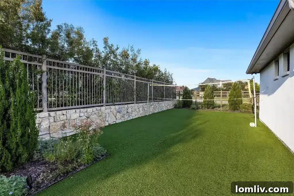 Spacious covered outdoor patio with seating, an outdoor kitchen, and a large television.