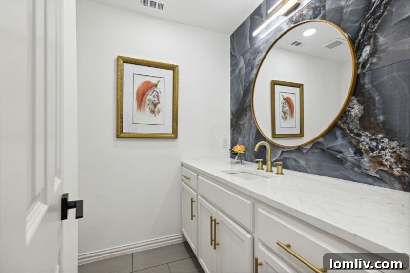 Cody Ellison and Ken Valencia Redefine Luxury in DeSoto 9 A luxurious guest bathroom featuring a striking marble accent wall and modern fixtures.