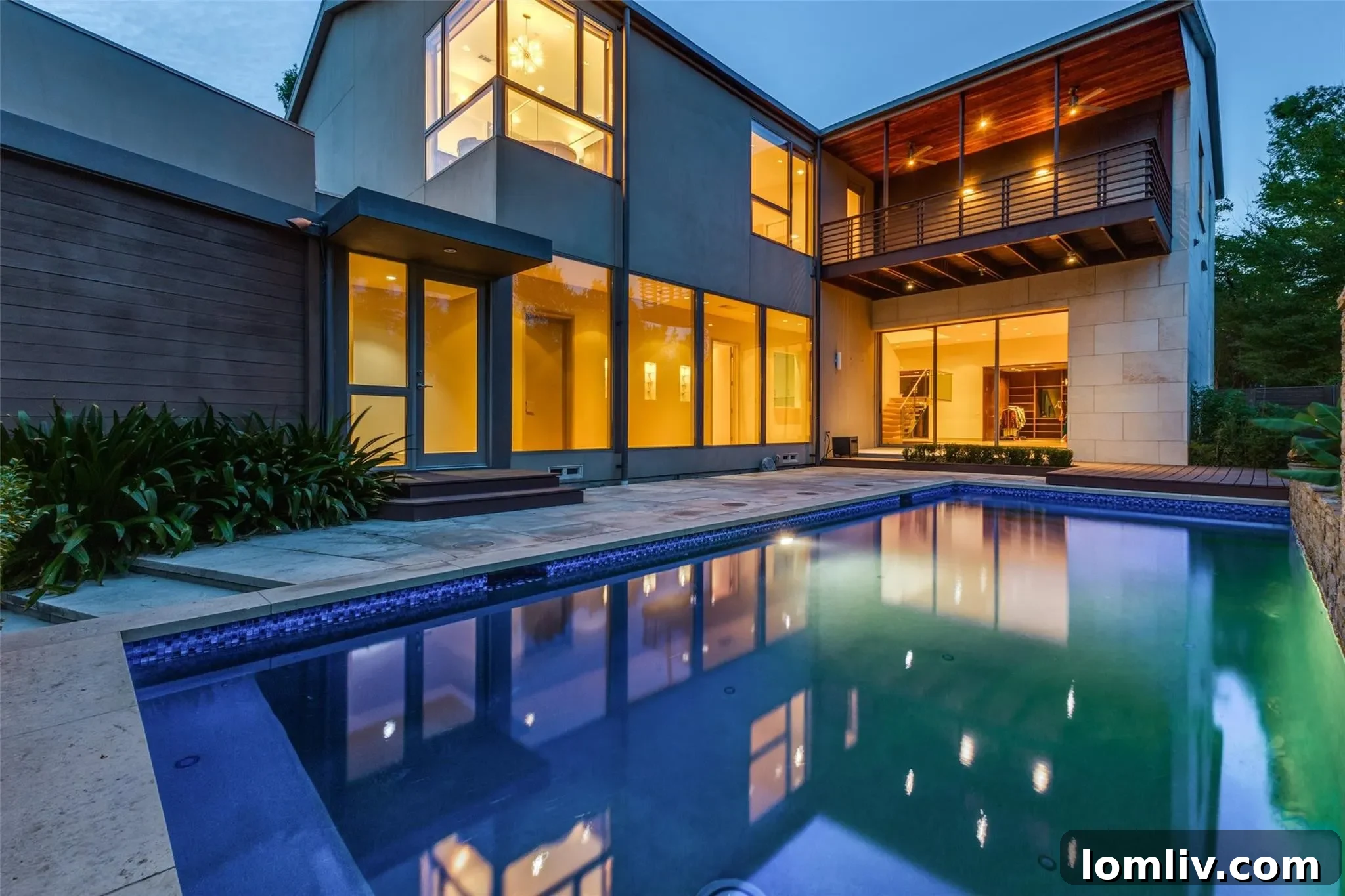 Secluded backyard with swimming pool, lush landscaping, and modern home exterior, emphasizing privacy