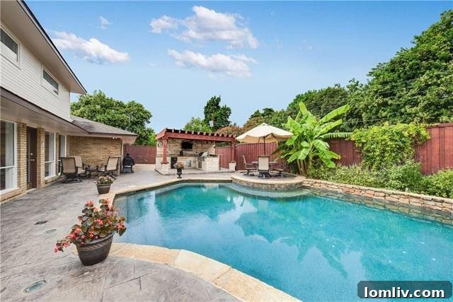 Outdoor living space with swimming pool and lush landscaping at 3823 Princess Ln
