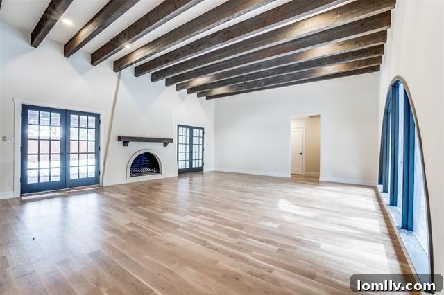 Spacious living room with original beamed ceilings and arched fireplace