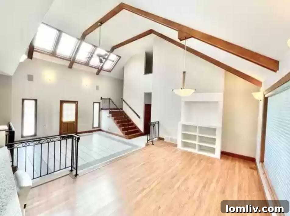Interior view of a spacious Tudor-style living area with hardwood floors, Monticello