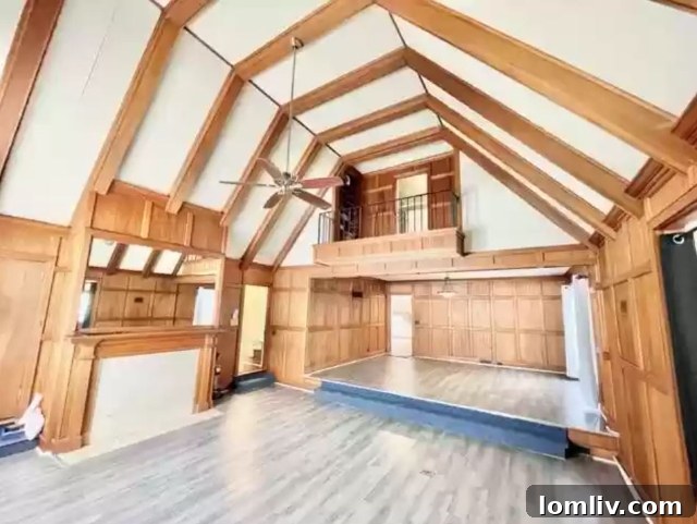 Tudor home interior with high ceilings, a balcony overlooking a great room, and a dance floor