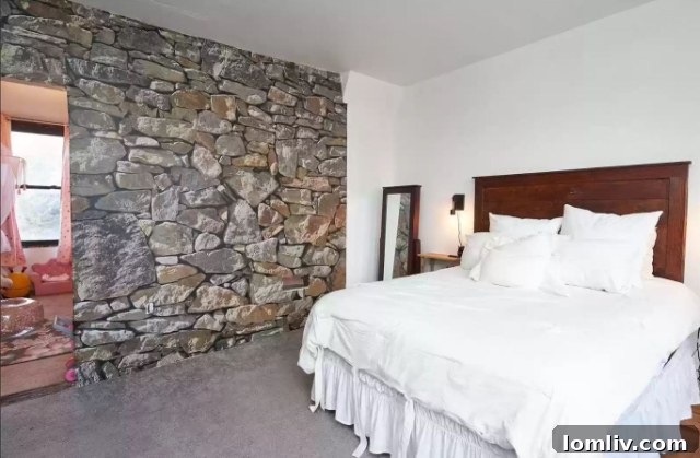 Interior room featuring a faux stone accent wall, creating a rustic castle ambiance