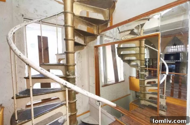 Winding staircase with strategically placed mirrors, adding depth and light