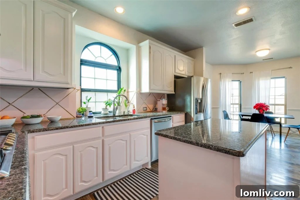 Modern kitchen with stainless steel appliances and ample counter space, perfect for entertaining.