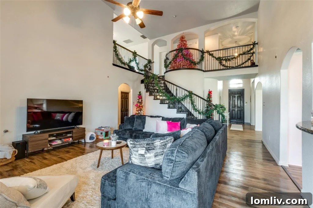 View from the living area towards the upstairs landing, highlighting the open-concept design and ample vertical space.
