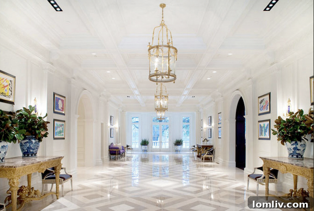 Luxurious foyer of the Kelli Ford home, featuring a grand staircase, exquisite flooring, and elegant decor that creates a welcoming and impressive first impression.