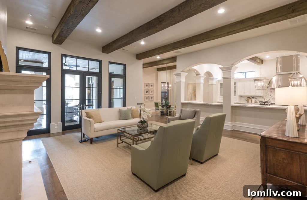 Spacious and modern custom home kitchen featuring high-end stainless steel appliances, a large island, and elegant custom cabinetry by Bella Custom Homes