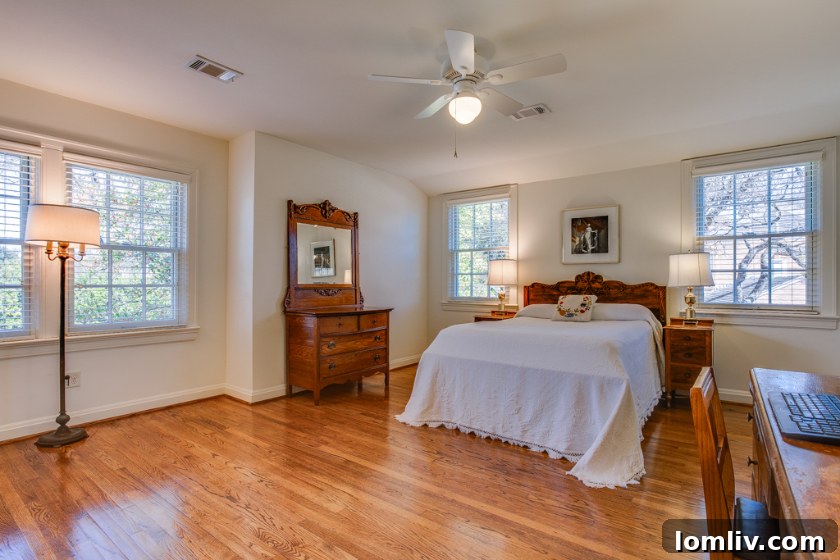 Cozy bedroom with ample natural light in a tastefully updated Colonial residence.