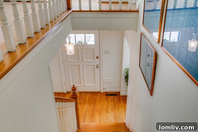 Inviting living room with fireplace and hardwood floors in a renovated Colonial home.
