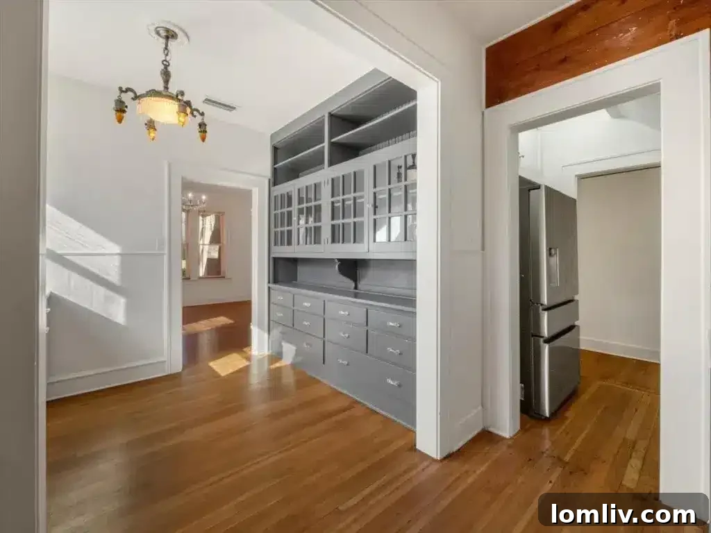 This Junius Heights Prairie-Style Home's Original Details Are A Vintage Lover's Dream 5 Spacious living room with a cozy gas fireplace, showcasing the home's blend of vintage charm and comfort.