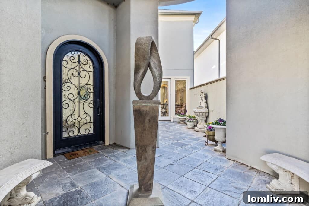 Elegant courtyard entrance with wrought iron gates and stone pathway