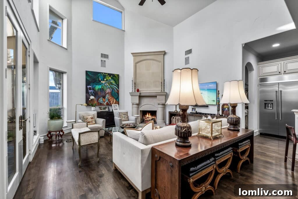 Spacious living room with high ceilings, large windows, and stone fireplace