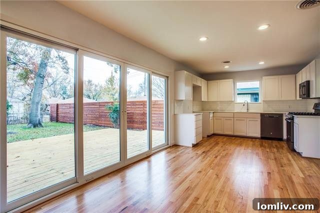 View of the open concept living space, showcasing the refinished hardwood floors and recessed lighting