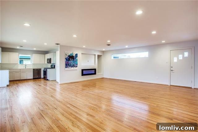 Another view of a bright bedroom featuring glistening hardwood floors in this renovated East Dallas home
