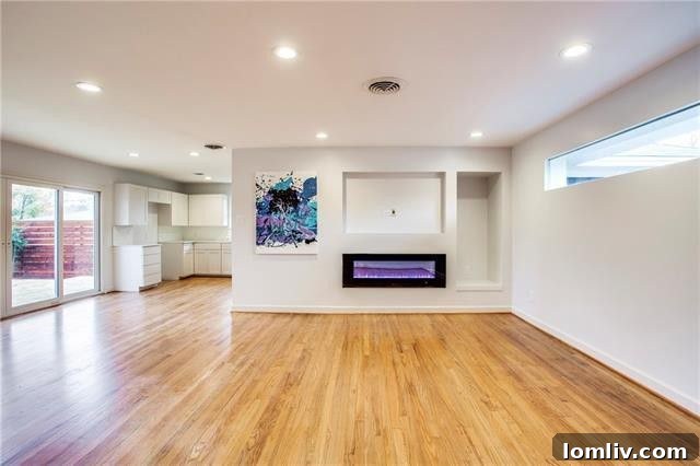 Elegant white shaker cabinets and quartz countertops in the fully renovated kitchen of this Dallas home