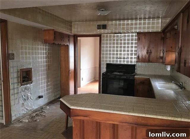 Southern Dallas Opportunities: Lawnview Station, Trinity Forest's Edge 12 Kitchen with knotty pine cabinets and metallic wallpaper at 7625 Blossom Lane