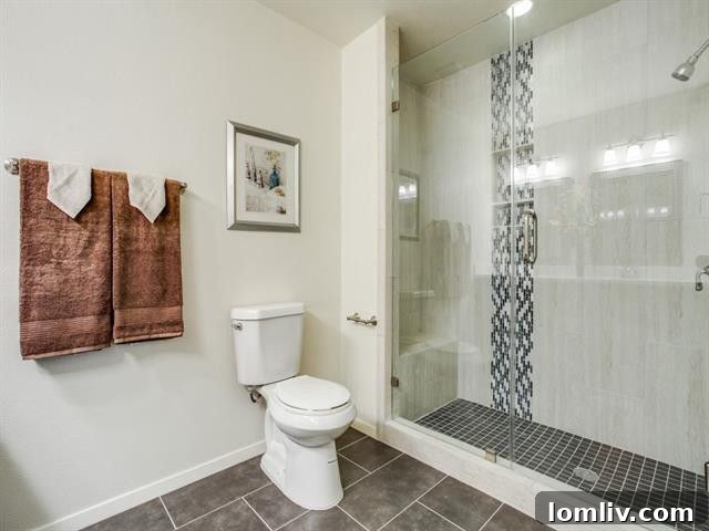 Luxurious master bathroom with new frameless glass shower and dual-sink vanity at 9421 Dartcrest Dr