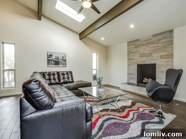 Bright and airy living room with vaulted, beamed ceilings and contemporary fireplace at 9421 Dartcrest Dr
