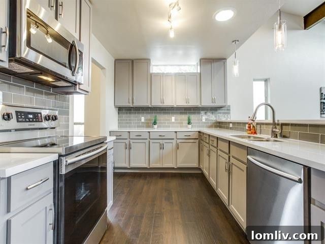 Modern kitchen with elegant marble countertops and glass subway tile backsplash in 9421 Dartcrest Dr