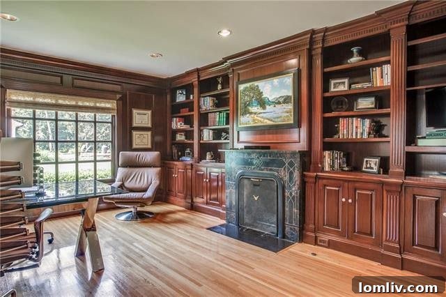 Masculine executive office with custom built-ins and a cozy fireplace