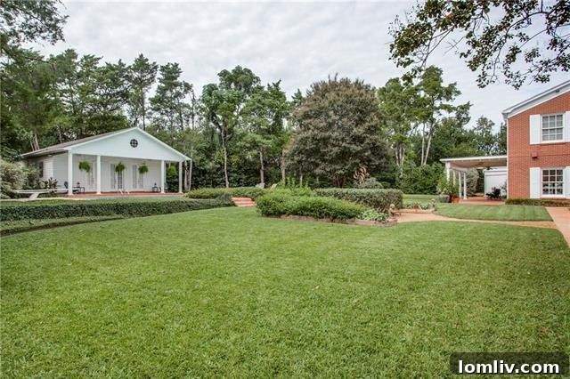 Expansive backyard with a view of the charming guest house