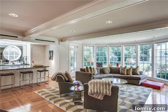 Luxurious round room with full-service bar and panoramic backyard views