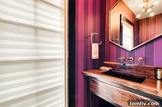 Luxurious powder bath with custom wallpaper and brass fixtures