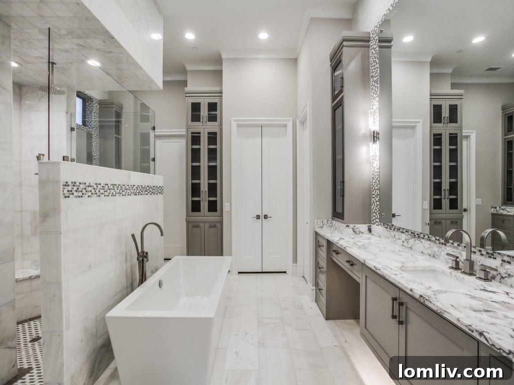 Luxurious Master Bathroom with Marble Finishes, Soaking Tub, and Elegant Accents