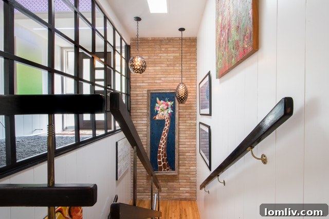 Stairwell with vintage lighting, exposed brick, and a giraffe painting