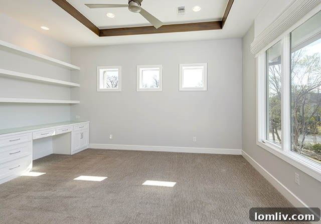 Spacious upstairs bedroom with large windows and built-in desk