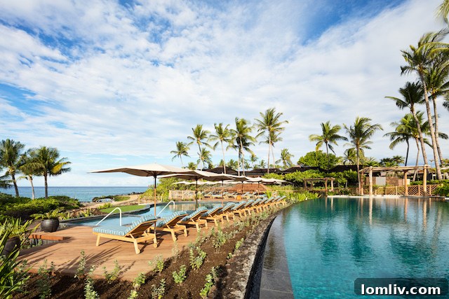 Traditional Hawaiian outrigger canoe on the serene waters off Hualālai Resort, Hawaii Island, with luxury beachfront properties in the background.