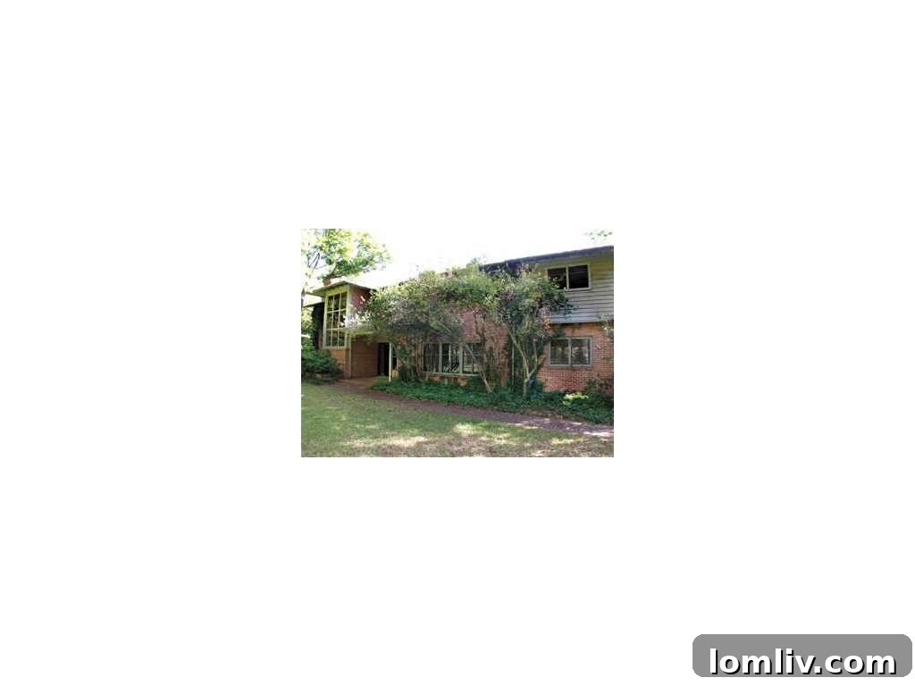 Exterior view of 9910 Inwood Road, a historic Dallas home on a large lot.