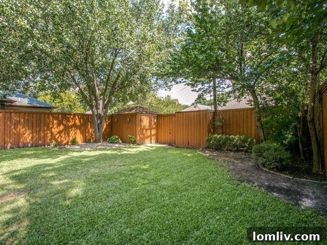 Spacious and serene backyard of the M-Streets Tudor with privacy fence