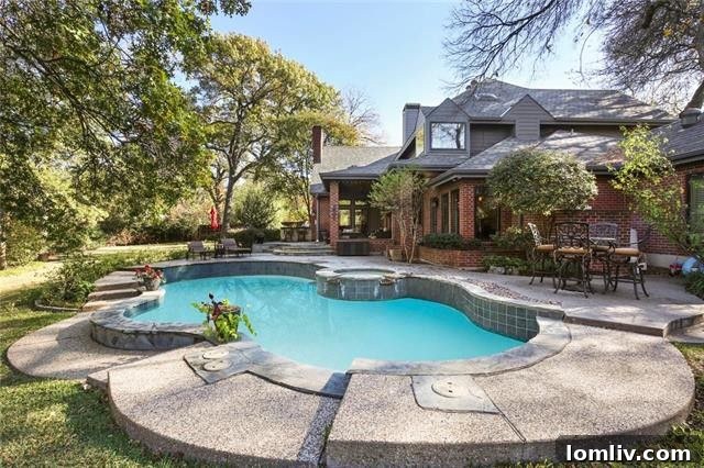 Elegant outdoor living area with fireplace at 5505 Windmier Cir