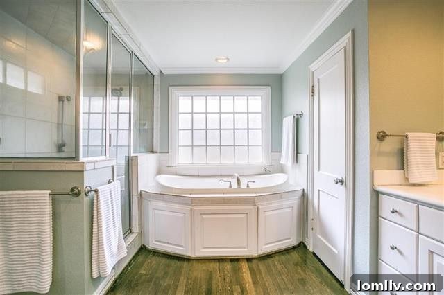 Luxurious master bathroom with a jetted tub, dual vanities, and an oversized shower.