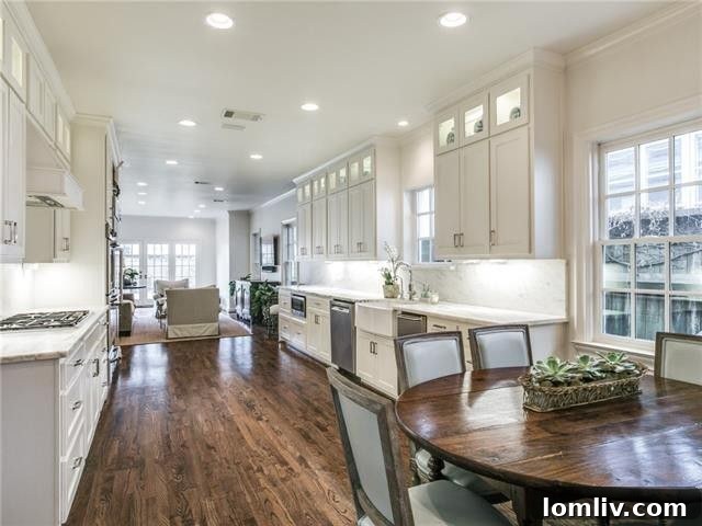 Bright and airy breakfast nook adjacent to the kitchen with large windows.